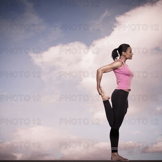 African American woman practicing yoga outdoors