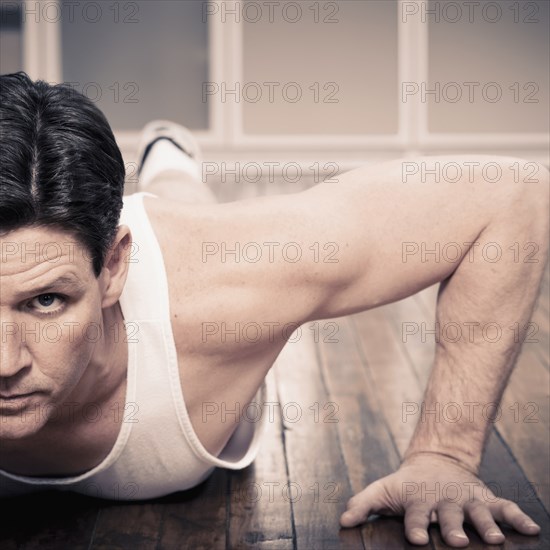 Man doing push ups indoors