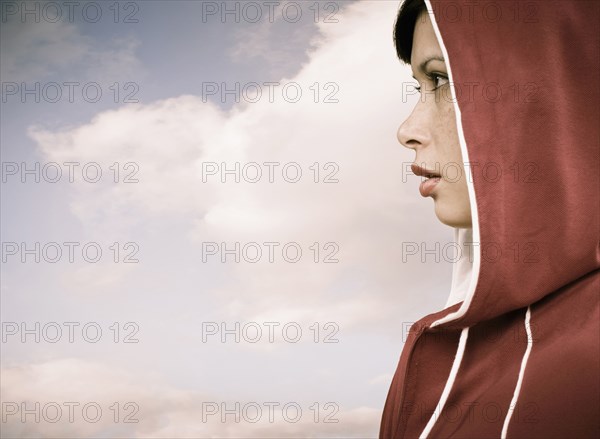 Mixed race woman wearing hoodie outdoors