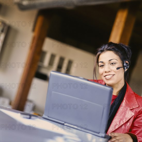 Businesswoman talking on headset in office