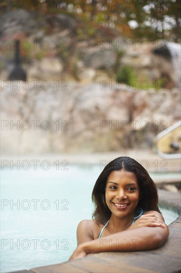 African woman sitting in hot tub