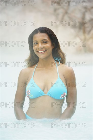 African woman standing in hot tub