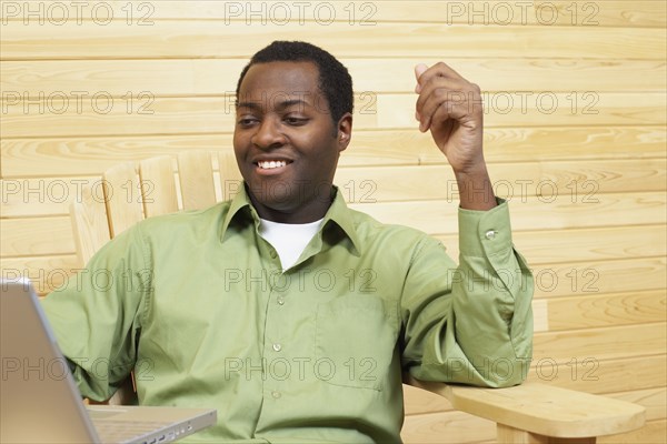 African man looking at laptop