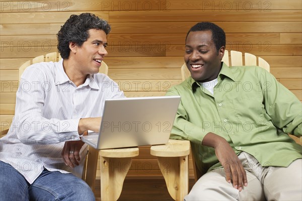 Two multi-ethnic men looking at laptop