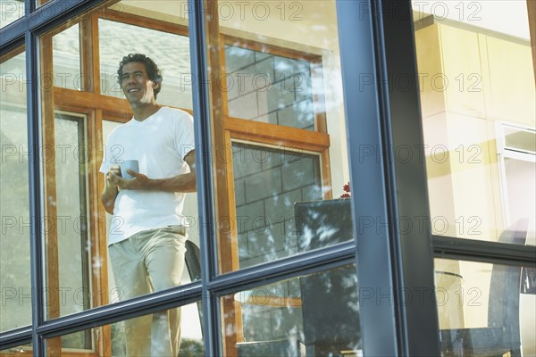 Man looking through window