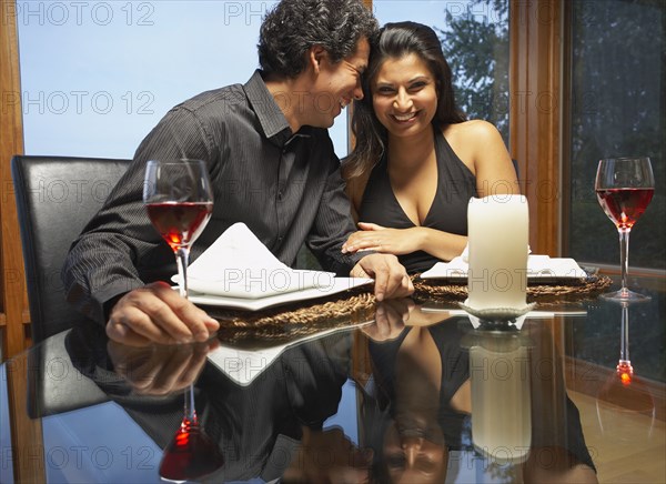 Couple hugging at table