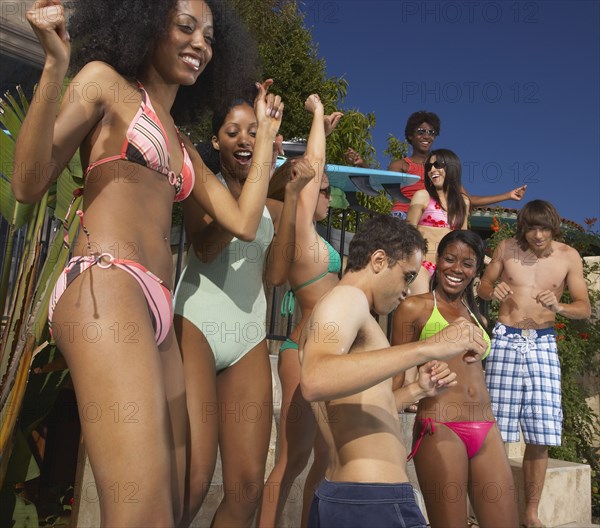 Multi-ethnic group of friends enjoying pool party