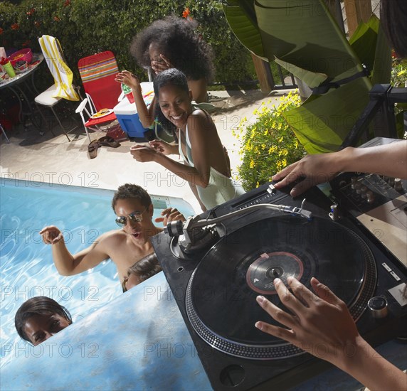 Multi-ethnic group of friends enjoying pool party