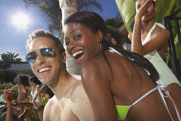 Multi-ethnic group of friends enjoying pool party