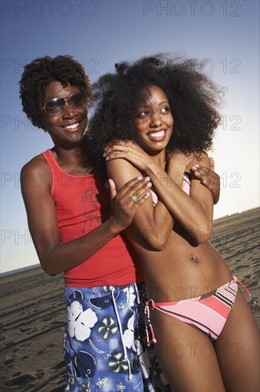 African couple hugging at beach