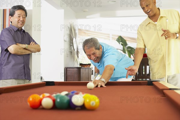 Multi-ethnic group of friends playing pool