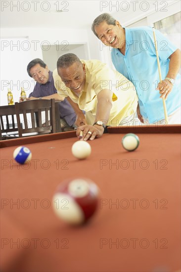Multi-ethnic group of friends playing pool