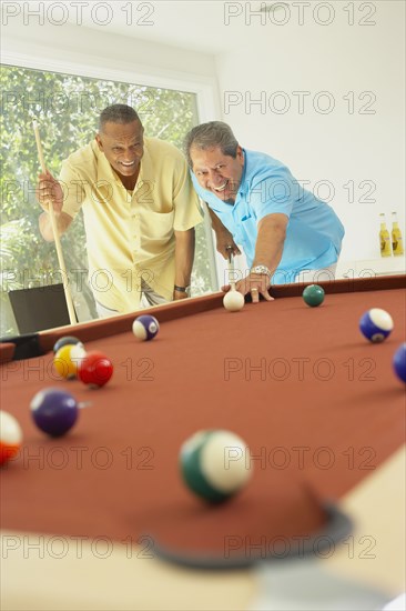 Multi-ethnic friends playing pool