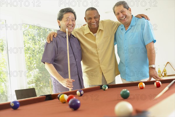 Multi-ethnic group of friends playing pool