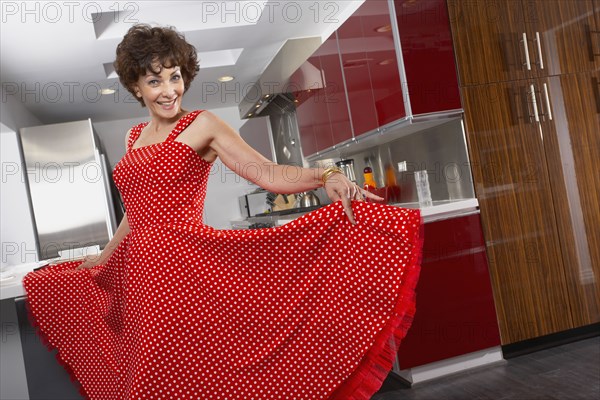 Glamorous mixed race woman posing in kitchen