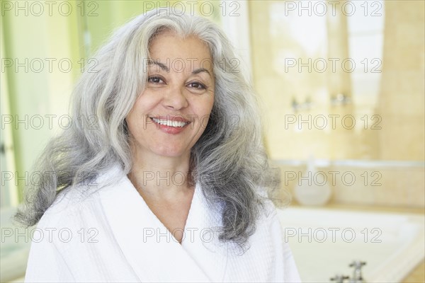 Smiling woman wearing bathrobe in spa