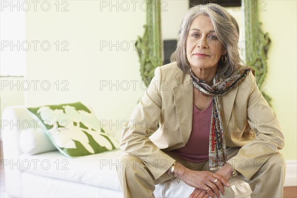 Confident woman sitting in living room