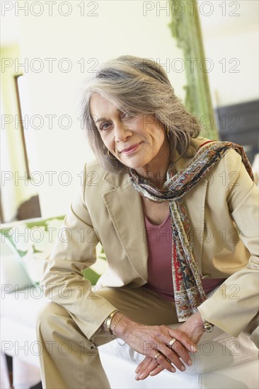Confident woman sitting in living room