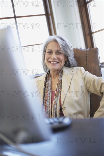 Confident businesswoman working on computer at desk