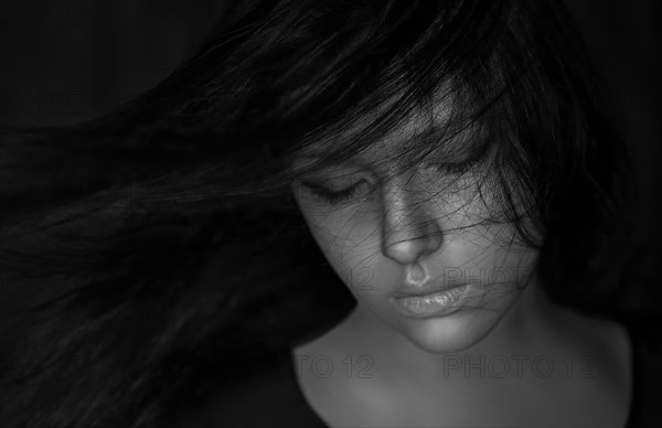 Wind blowing hair of Caucasian woman