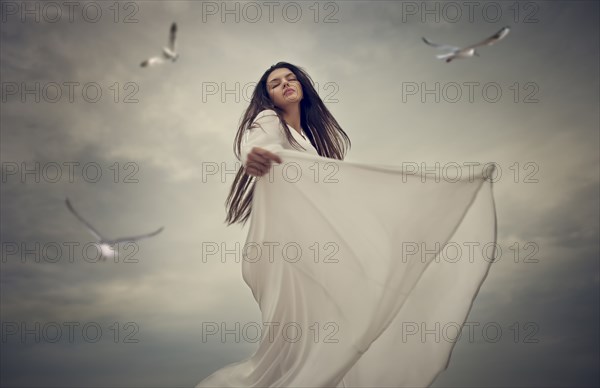 Birds flying near dancing Caucasian woman