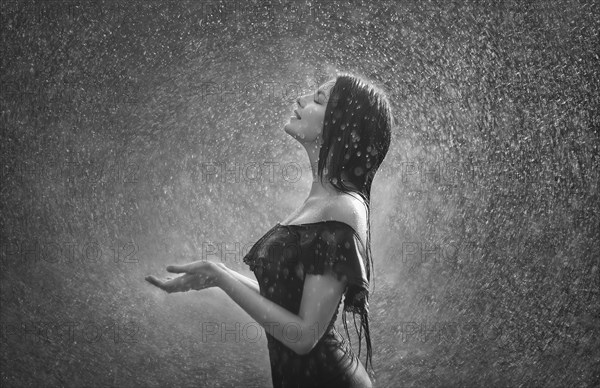 Smiling Caucasian woman standing in rain