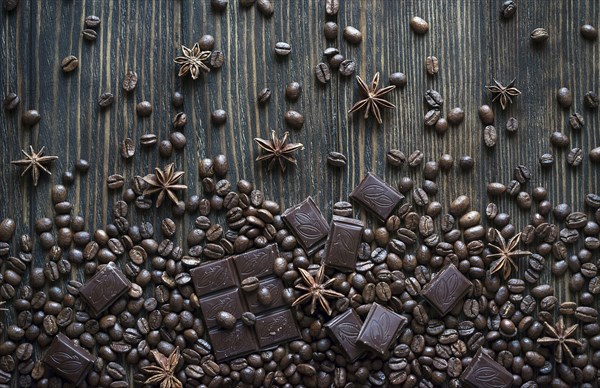 Cocoa beans and chocolate bars on wooden table