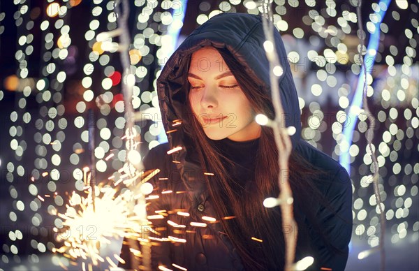 Caucasian woman holding sparkler