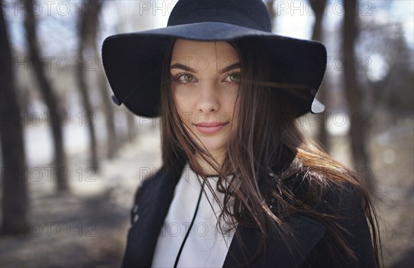 Wind blowing hair of woman wearing hat