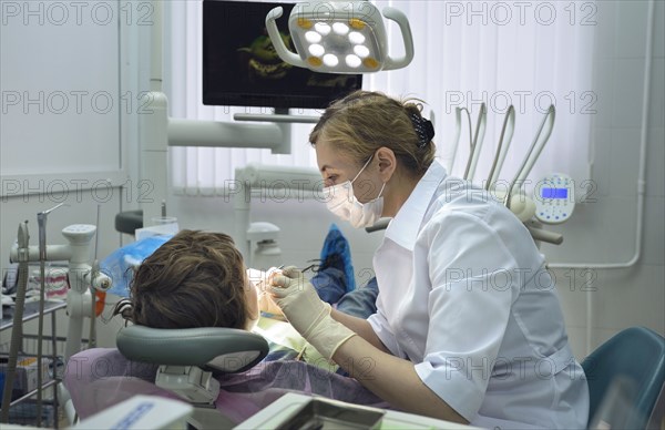 Dentist treating boy