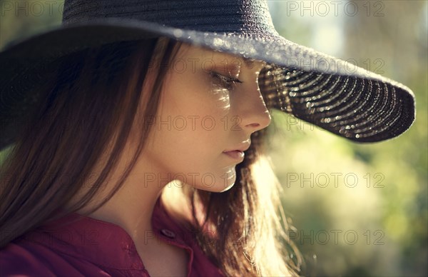 Close up of pensive Caucasian teenage girl wearing hat