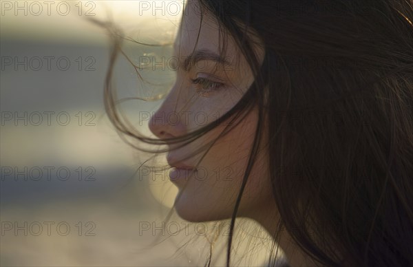 Wind blowing hair of Caucasian woman