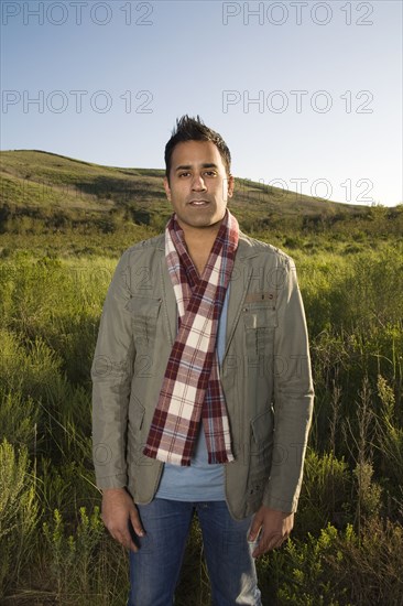 Mixed race standing in field