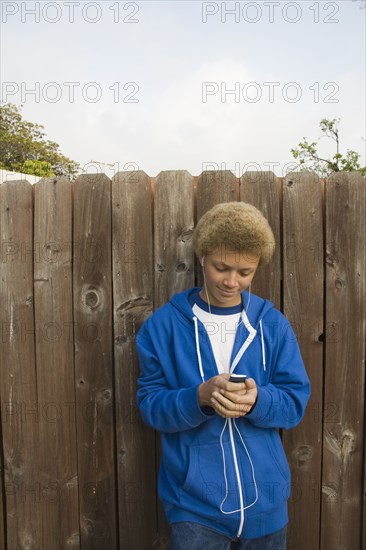 Mixed race boy listening to mp3 player