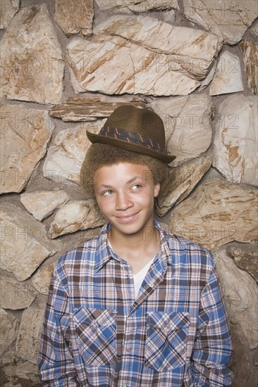 Mixed race boy wearing fedora