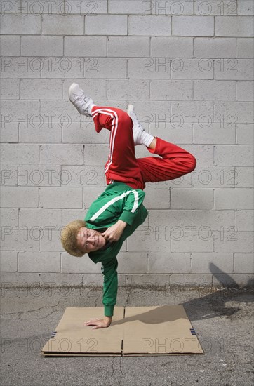 Mixed race boy breakdancing