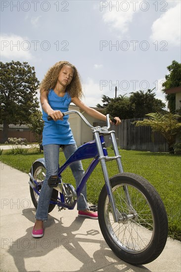 Mixed race girl on bicycle