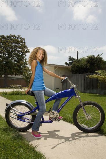 Mixed race girl on bicycle