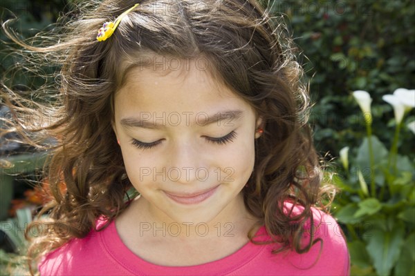 Hispanic girl smiling in garden