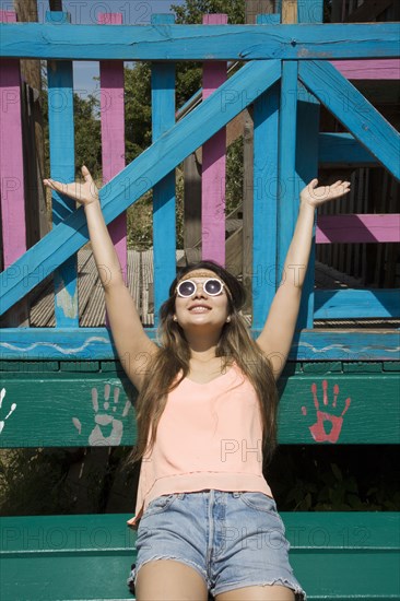 Asian woman cheering outdoors