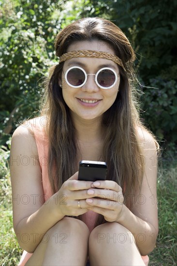 Asian woman using cell phone outdoors