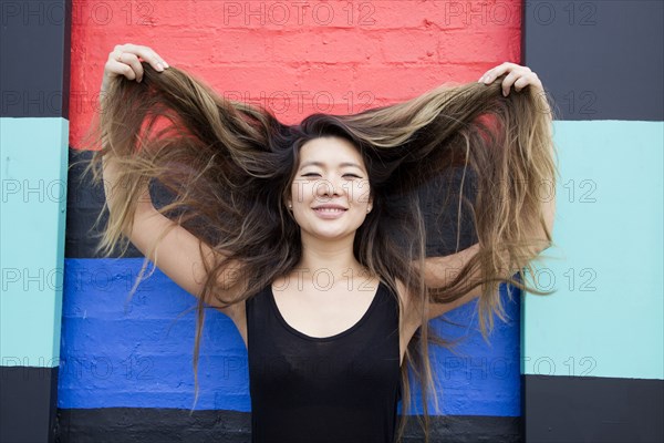 Asian woman playing with hair