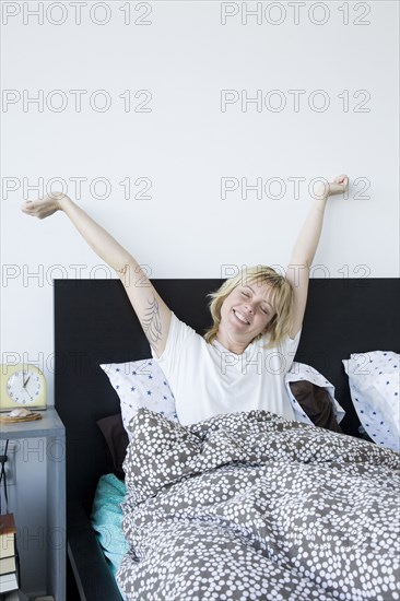 Caucasian woman waking in bed