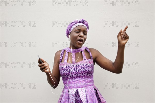 Black woman dancing to music on cell phone