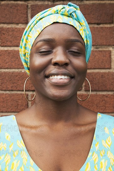 Portrait of smiling Black woman with eyes closed