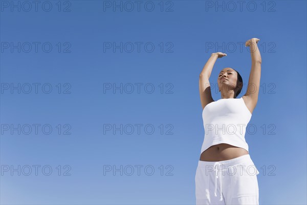 Hispanic woman practicing yoga