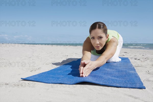 Hispanic woman practicing yoga