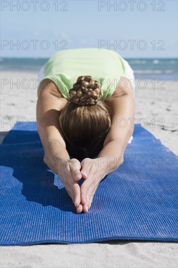 Hispanic woman practicing yoga