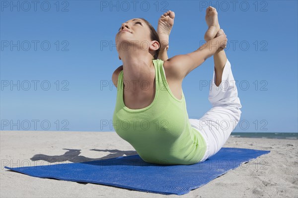 Hispanic woman practicing yoga