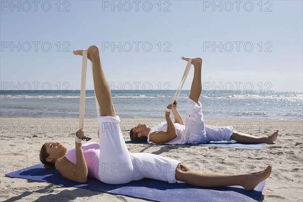 Hispanic couple practicing yoga